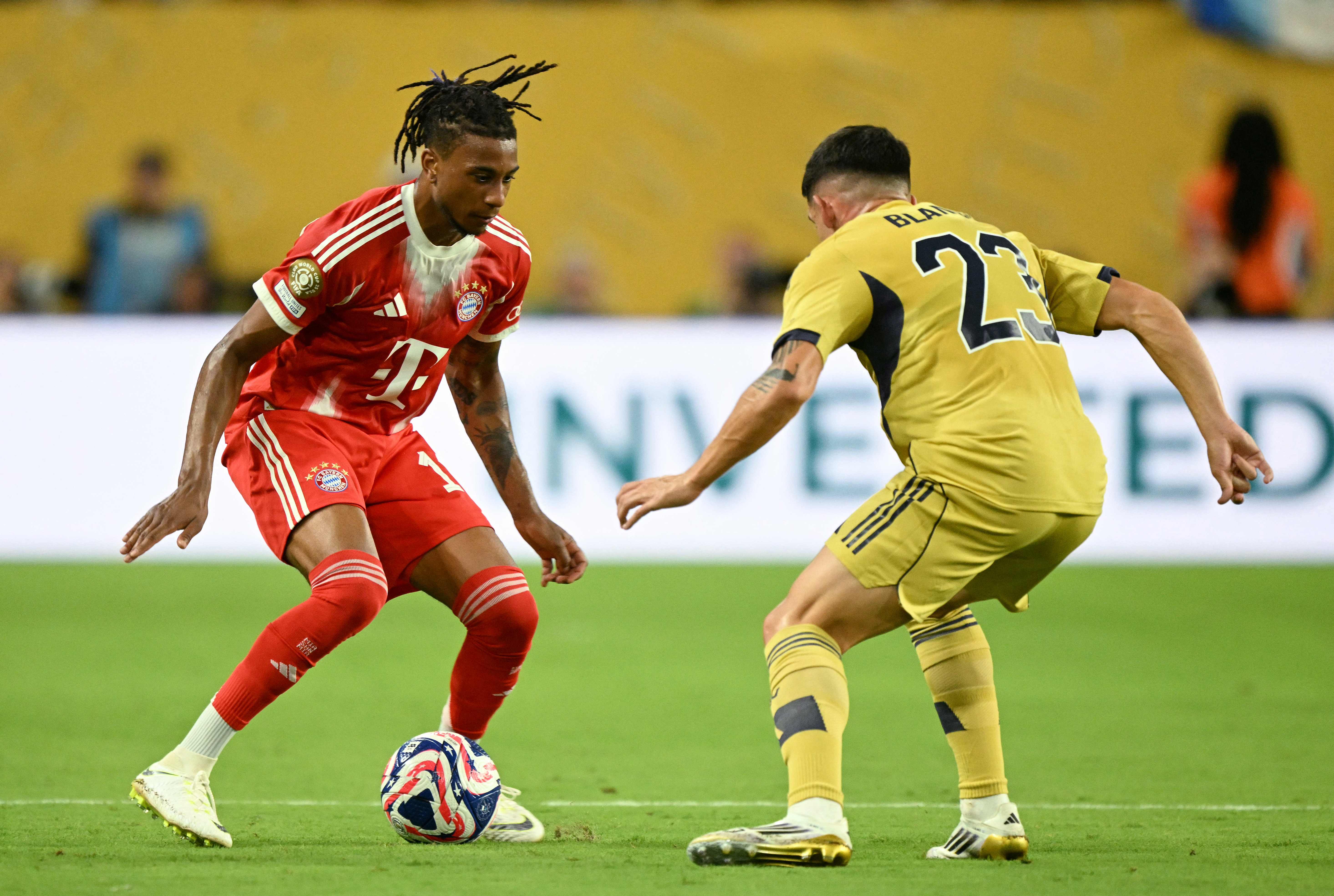 Bayern Munich's French midfielder #17 Michael Olise and Boca Juniors' Argentine defender #23 Lautaro Blanco fight for the ball during the FIFA Club World Cup 2025 Group C football match between Germany's Bayern Munich and Argentina's Boca Juniors at the Hard Rock stadium in Miami on June 20, 2025. (Photo by Chandan KHANNA / AFP)