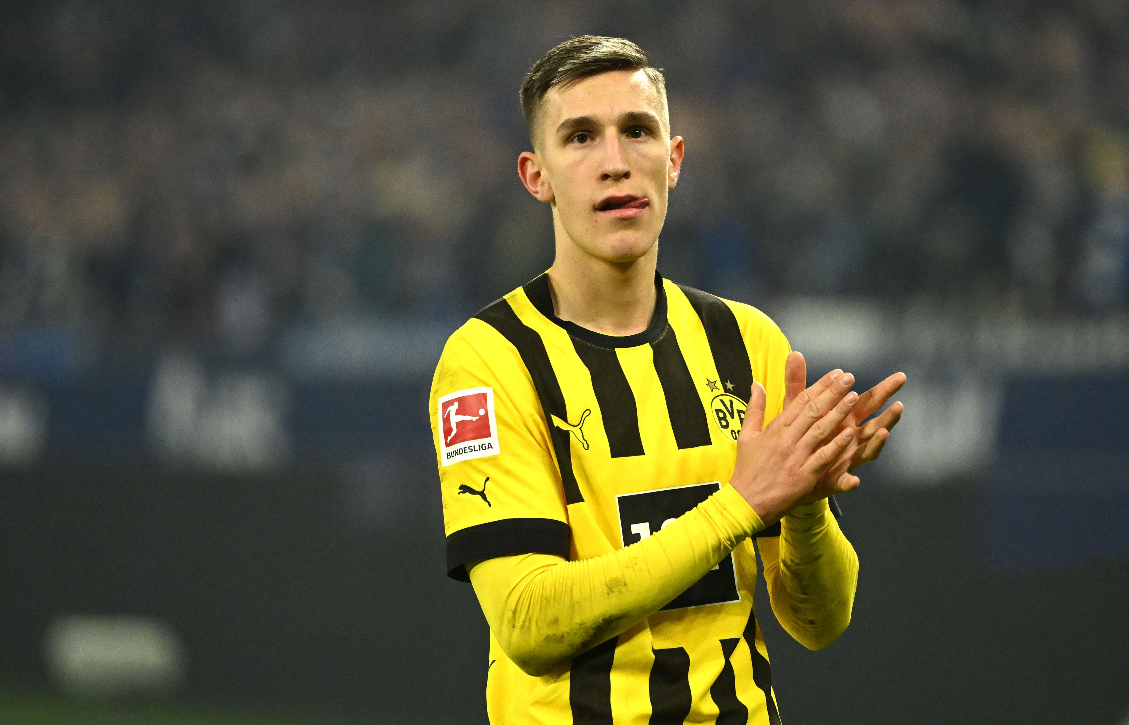 Dortmund's German defender Nico Schlotterbeck reacts after the German first division Bundesliga football match between FC Schalke 04 and BVB Borussia Dortmund in Gelsenkirchen, western Germany, on March 11, 2023. (Photo by INA FASSBENDER / AFP) / DFL REGULATIONS PROHIBIT ANY USE OF PHOTOGRAPHS AS IMAGE SEQUENCES AND/OR QUASI-VIDEO