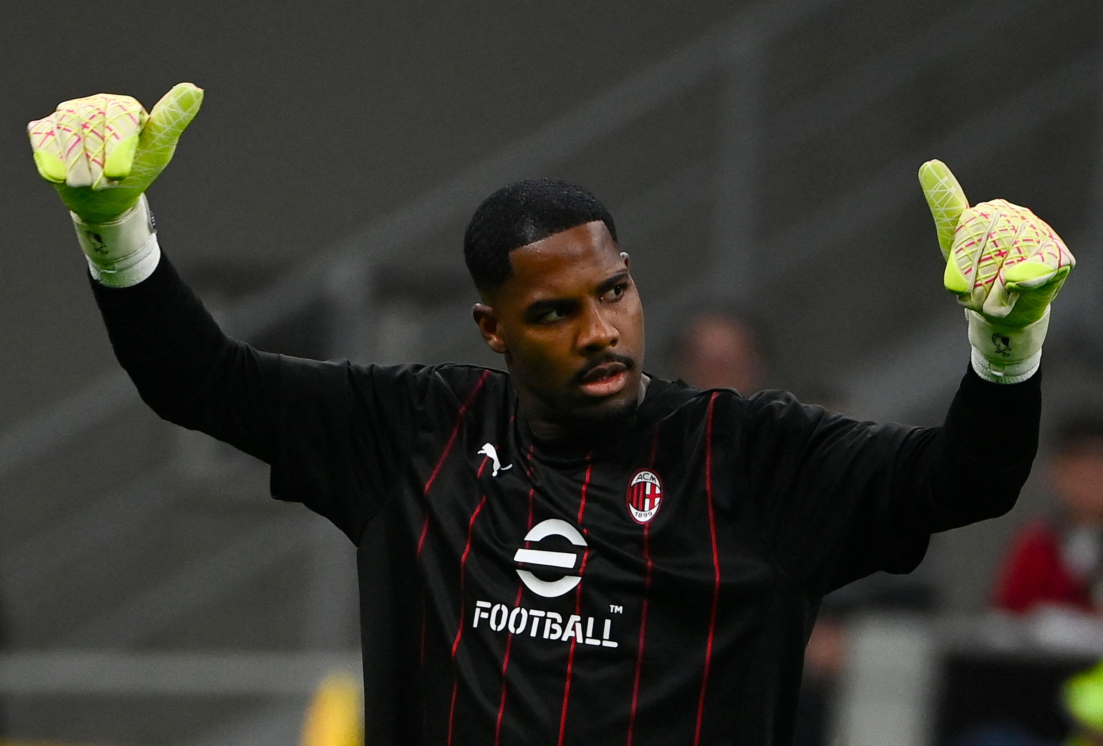 AC Milan's French goalkeeper #16 Mike Maignan gestures during the warm up ahead of the Coppa Italia first leg semifinal football match AC Milan vs Inter Milan at San Siro stadium in Milan on April 2, 2025. (Photo by Isabella BONOTTO / AFP)