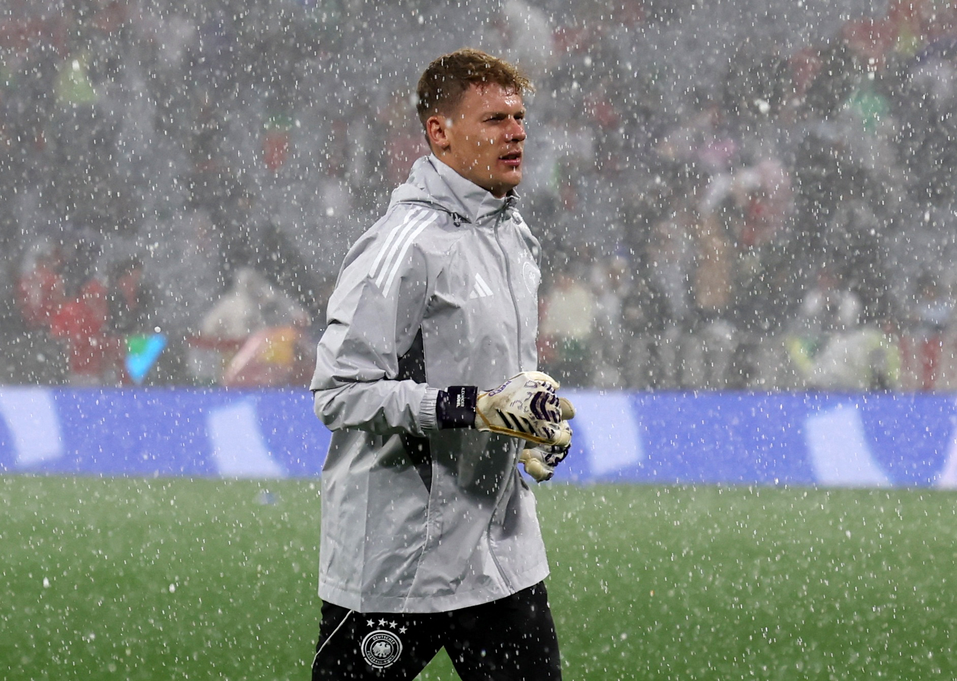 Soccer Football - Nations League - Semi Final - Germany v Portugal - Allianz Arena, Munich, Germany - June 4, 2025 Germany's Alexander Nubel during the warm up as hail stones are seen falling on the pitch before the match REUTERS/Michaela Stache