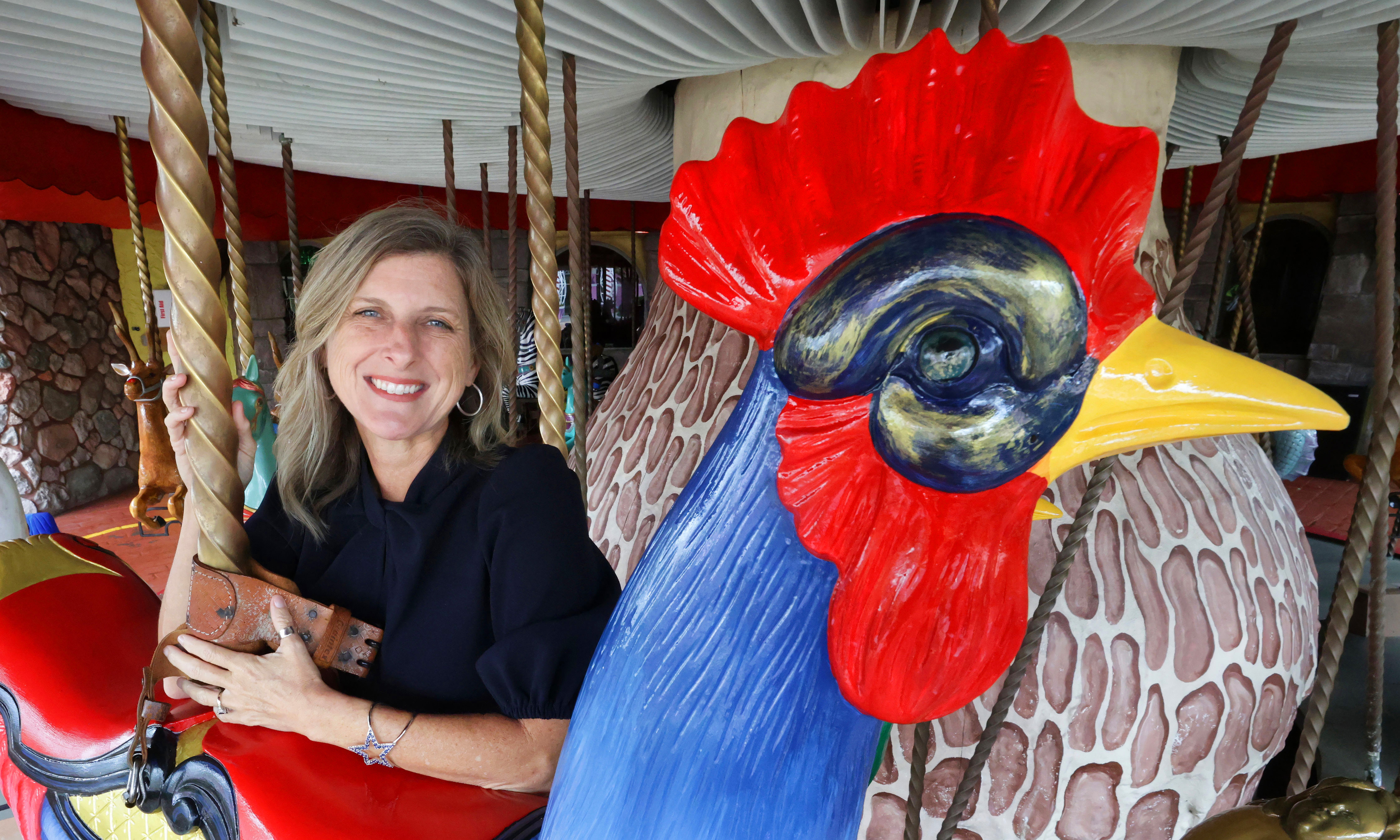 Caroline Schumacher, nueva presidenta y directora ejecutiva de Give Kids the World, en el icónico carrusel de la aldea infantil, en Kissimmee el lunes 6 de octubre de 2025. Schumacher fue nombrada para el puesto de liderazgo en junio. (Joe Burbank/Orlando Sentinel)