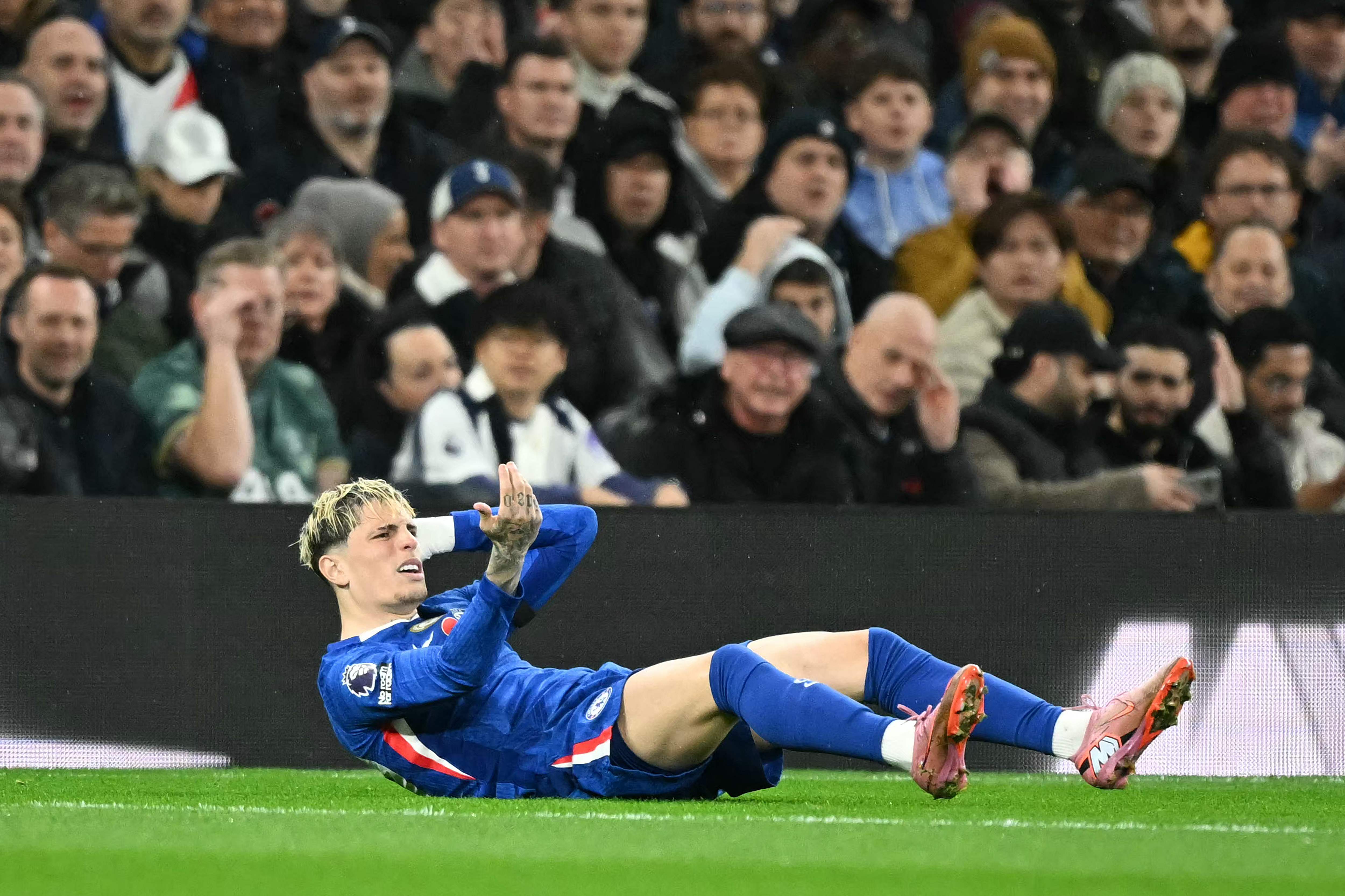 Chelsea's Argentinian midfielder #19 Alejandro Garnacho reacts after being chaleneged by Tottenham Hotspur's Spanish defender #23 Pedro Porro (unseen) during the English Premier League football match between Tottenham Hotspur and Chelsea at the Tottenham Hotspur Stadium in London, on November 1, 2025. (Photo by JUSTIN TALLIS / AFP) / RESTRICTED TO EDITORIAL USE. No use with unauthorized audio, video, data, fixture lists, club/league logos or 'live' services. Online in-match use limited to 120 images. An additional 40 images may be used in extra time. No video emulation. Social media in-match use limited to 120 images. An additional 40 images may be used in extra time. No use in betting publications, games or single club/league/player publications. / 