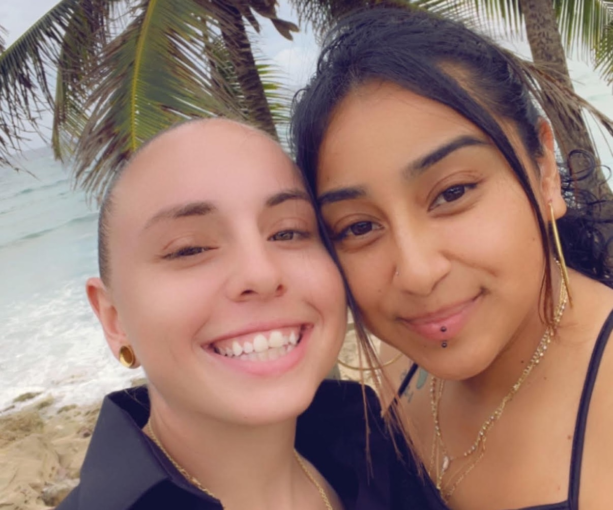 Gina Mustacchio, left, and Delmy Alvarez pose for a selfie in the summer of 2022 on a beach in Puerto Rico while on the island for a friend's wedding. 