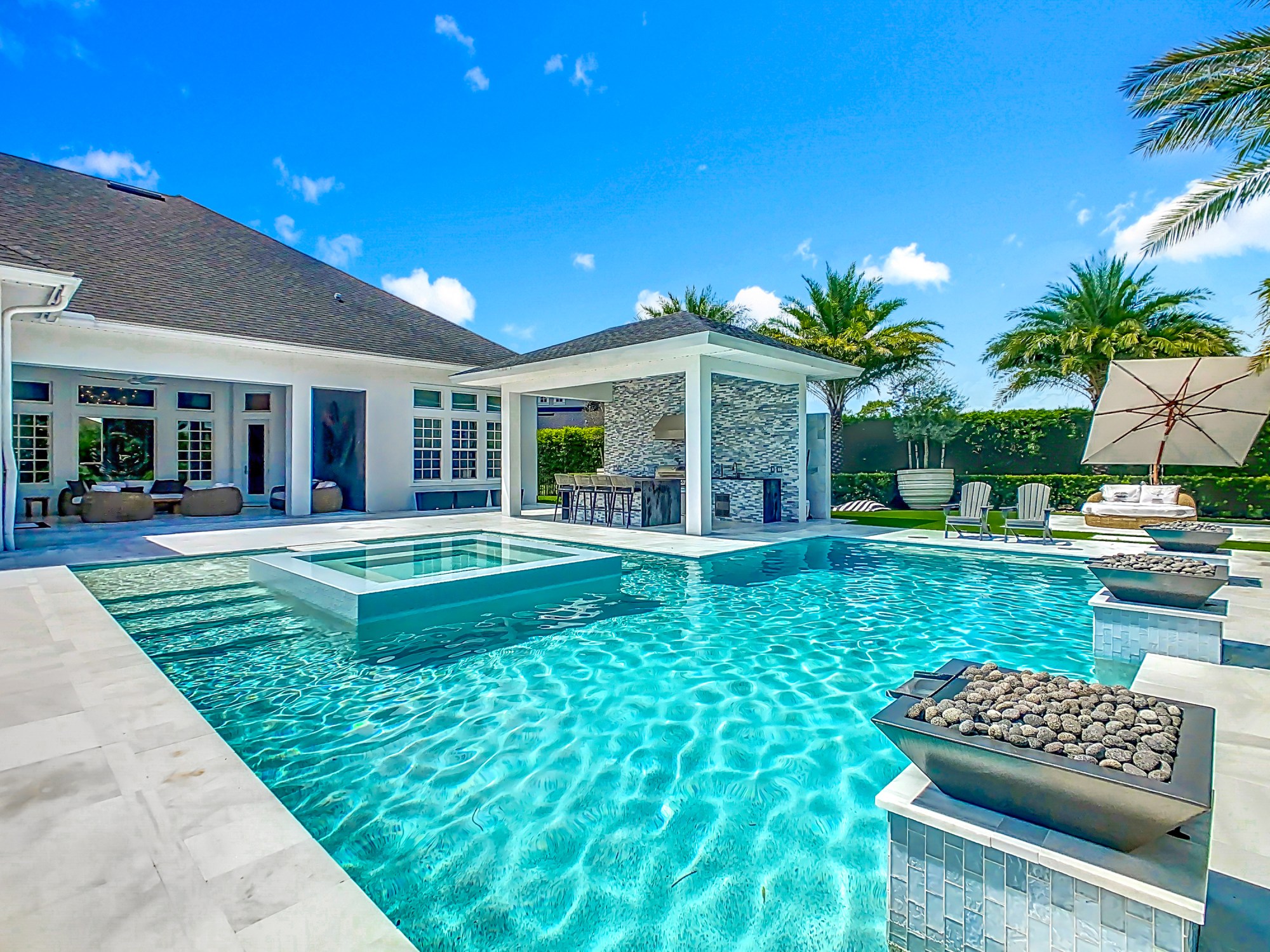 Esta piscina única en su tipo incluye un spa central al que se debe acceder mediante escalones de piedra. También cuenta con fuentes y elementos de fuego. (Foto de Tyto Media)